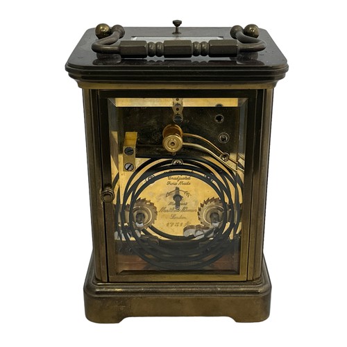 126 - A brass cased carriage clock with bevelled glass panels, Matthew Norman of London, complete with key... 