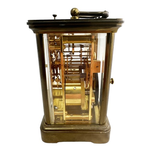 126 - A brass cased carriage clock with bevelled glass panels, Matthew Norman of London, complete with key... 