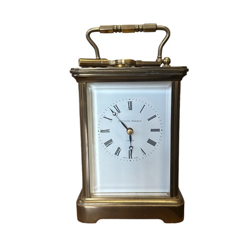 126 - A brass cased carriage clock with bevelled glass panels, Matthew Norman of London, complete with key... 