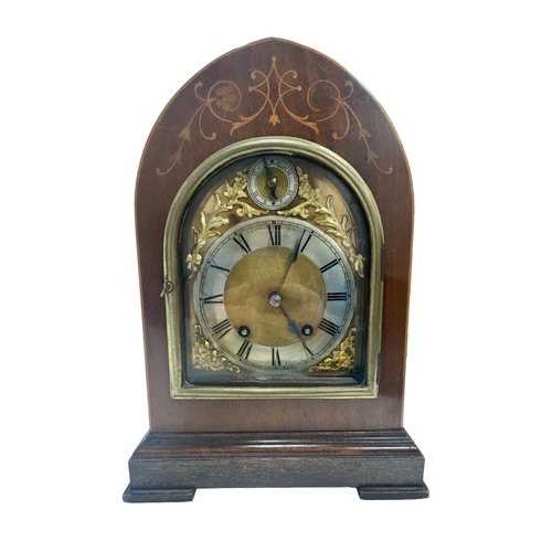 124 - An arch topped mantel clock by the Kemp Brothers of Union St, Bristol. Inlaid mahogany case, silvere... 