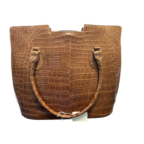 91 - A crocodile skin (possibly faux) handbag with leather interior. Dimensions approx 29cm x 24cm.