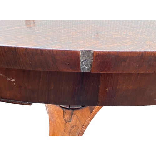 185 - Late Regency William IV rosewood breakfast table with triform base and paw feet. Diameter 130cm.