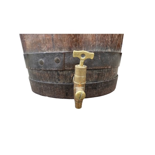 11 - Banded oak barrel with brass tap, height 35cm, diameter 38cm.