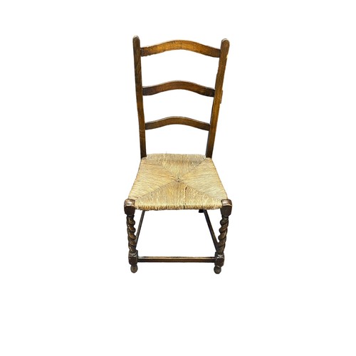 394 - Victorian mahogany shield back hall chair plus two oak rush seat early 20th Century chairs.