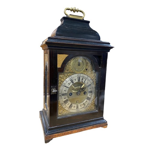 134 - 18th Century ebony veneered bracket clock. The arched brass dial with 'Strike/Silent' dial to the ar... 