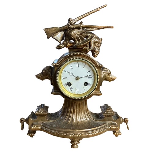 122 - Spelter bell strike mantel clock with hunting theme, hounds heads to left and right of porcelain dia... 