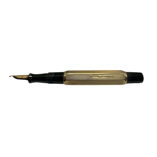 24 - A Waterman Ideal lever fill fountain pen with a 9ct engine turned gold cap and barrel cover having W... 