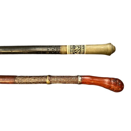 309 - Pair of sword sticks, one with lions head design to top and 