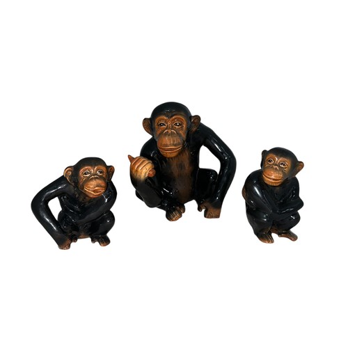 513 - Sylvac, a trio of Sylvac seated monkey figurines, larger monkey holding a piece of fruit (height 17c... 