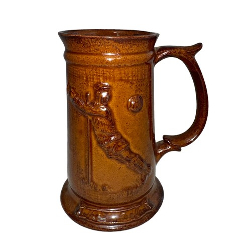 516 - A Studio glazed Football tankard/stein/mug with image of a diving goalkeeper ‘the footballer’, lustr... 