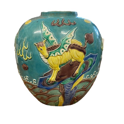 86 - A large turquoise coloured oriental ginger jar with raised decoration featuring two dragons and a wi... 