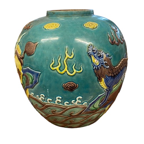 86 - A large turquoise coloured oriental ginger jar with raised decoration featuring two dragons and a wi... 