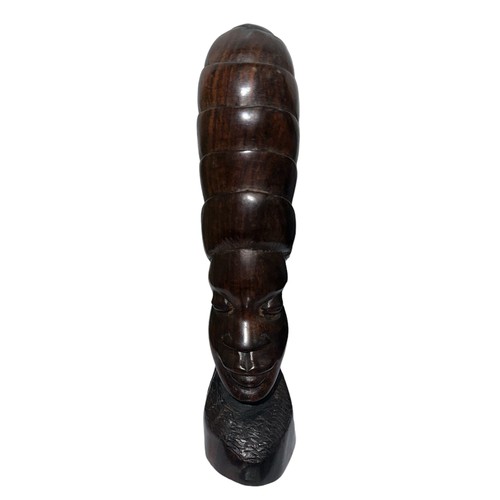 279 - A standing African carved wooden sculpture in the shape of a woman’s head with a phallic design and ... 