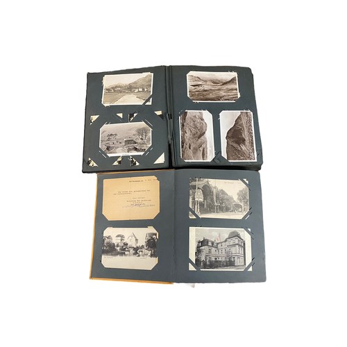 673 - Collection of postcards in three old albums, mainly printed but some RP's, small foreign selection, ... 