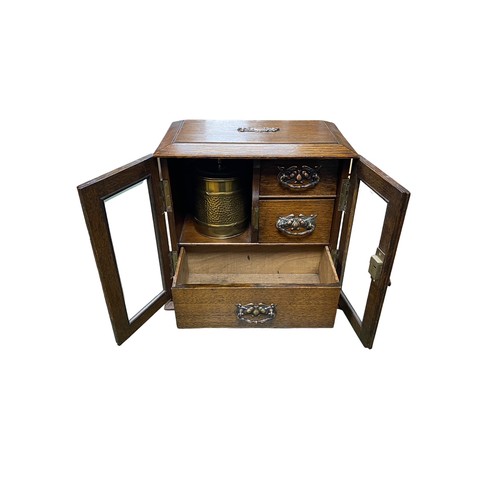 258 - Smokers cabinet with two bevelled glass doors, three internal drawers with brass drop handles, brass... 