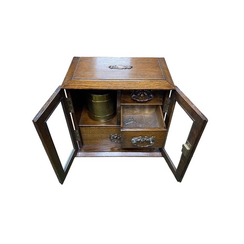 258 - Smokers cabinet with two bevelled glass doors, three internal drawers with brass drop handles, brass... 