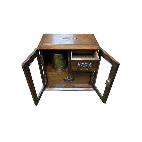 258 - Smokers cabinet with two bevelled glass doors, three internal drawers with brass drop handles, brass... 