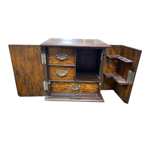 259 - Smokers cabinet with two doors to front, three internal drawers with drop handles, pipe rack, shield... 