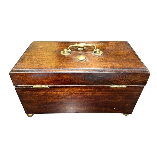 285 - A mahogany hinged-lid tea caddy on four brass round ball feet. Three compartments, brass handle on l... 