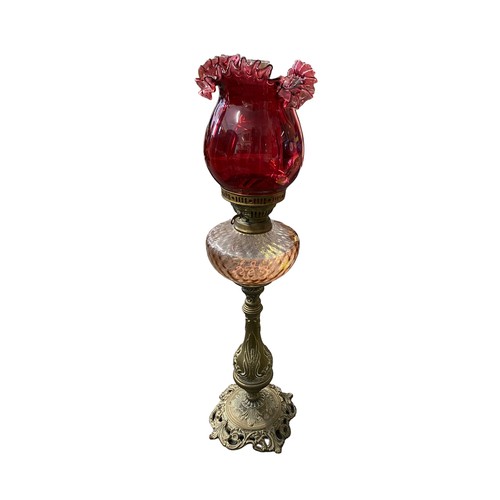 470 - A very good Victorian cast gilt brass Cranberry glass standing oil lamp, foliage design to base and ... 