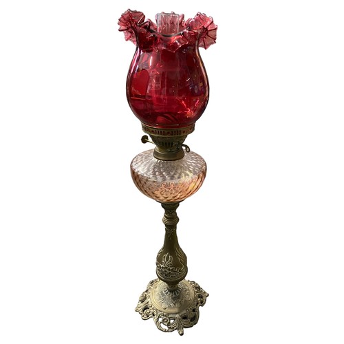 470 - A very good Victorian cast gilt brass Cranberry glass standing oil lamp, foliage design to base and ... 