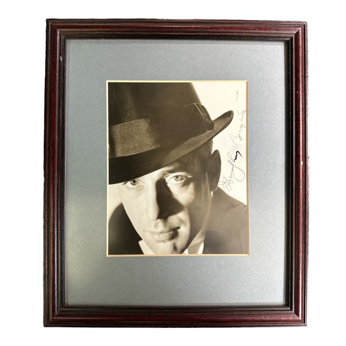 542 - Humphrey Bogart (1899-1957) – A framed black and white photograph signed by Humphrey Bogart in black... 