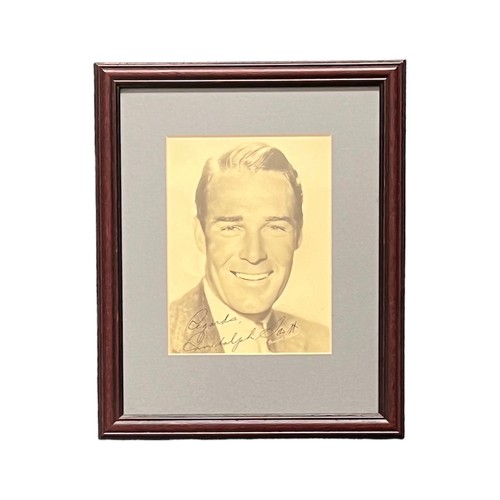 559 - Randolph Scott (1898-1987) – Pair of framed photographs signed by Randolph Scott to include; a black... 