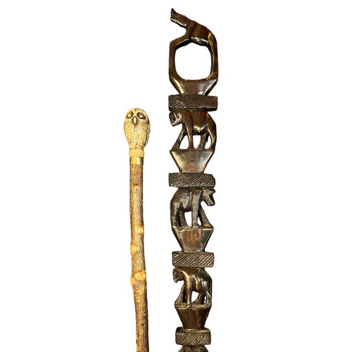 305 - Collection of twelve walking sticks, several with interesting carvings including an owl, African ani... 