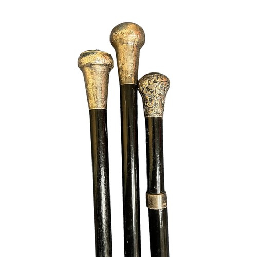 307 - Collection of thirteen walking sticks, mostly with white metal tops, three have obscured hallmarks.