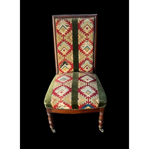 324 - Mahogany chair with kilim upholstery on turned legs with brass casters to front, height 87cm.