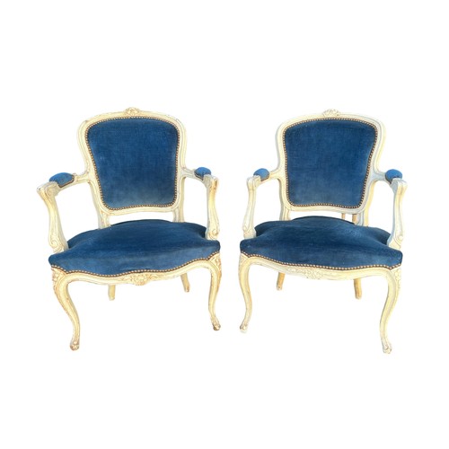 293 - A pair of French Louis XV style open arm salon chairs, carved frames painted white with cabriole fro... 