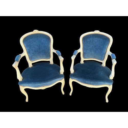 293 - A pair of French Louis XV style open arm salon chairs, carved frames painted white with cabriole fro... 