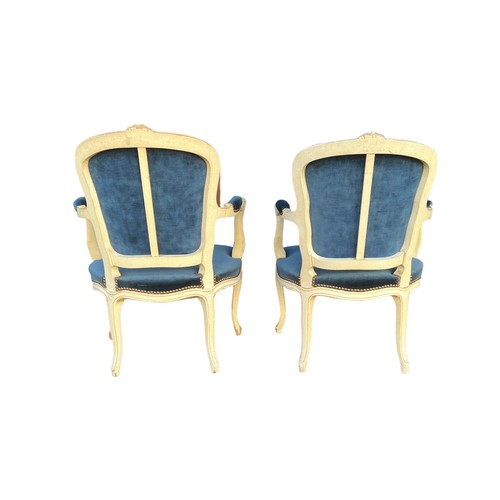 293 - A pair of French Louis XV style open arm salon chairs, carved frames painted white with cabriole fro... 