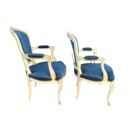 293 - A pair of French Louis XV style open arm salon chairs, carved frames painted white with cabriole fro... 