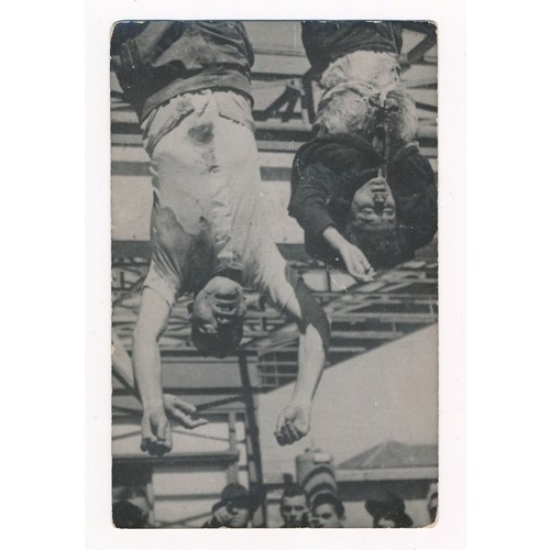 680 - A black and white photographic postcard of Benito Mussolini and Claretta Petacci hanging, the fascis... 