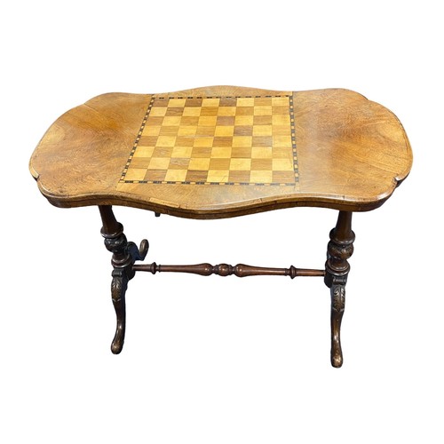 469 - Walnut chequered top games table with H-frame stretcher, width 90cm, depth 54cm and height 68cm.