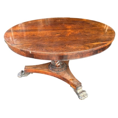 185 - Late Regency William IV rosewood breakfast table with triform base and paw feet. Diameter 130cm.