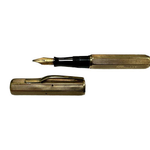 24 - A Waterman Ideal lever fill fountain pen with a 9ct engine turned gold cap and barrel cover having W... 