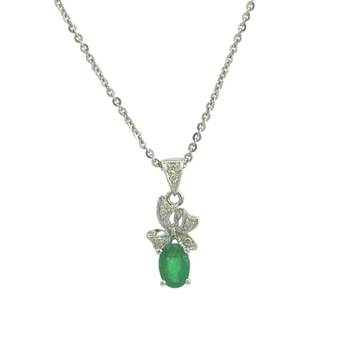 410 - A 0.4ct emerald set in a diamond and 18ct white gold pendant with an 18ct white gold chain. 2.7g