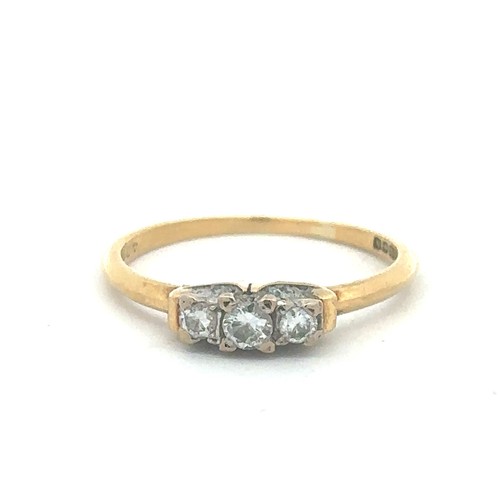 494 - An 18ct gold three stone diamond ring. Hallmarks for Birmingham. Total diamond weight approx 0.16ct.... 