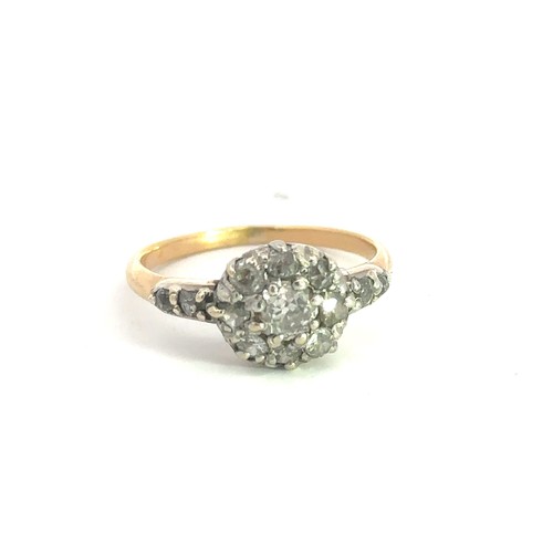 463 - A gold and old cut diamond cluster ring, stamped 18. Central diamond approx 0.25ct surrounded by 8 f... 