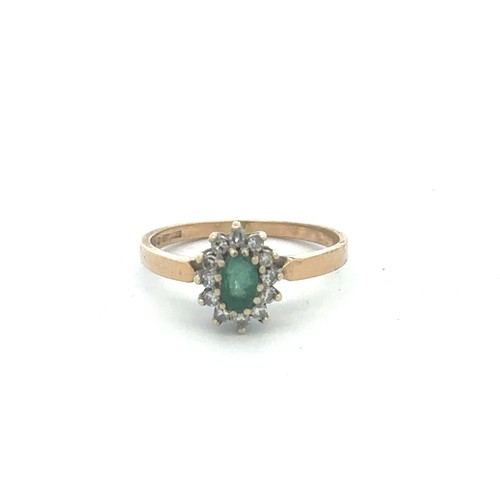 465 - An Emerald and diamond cluster ring set in 9ct gold, hallmarks for Birmingham, size K.