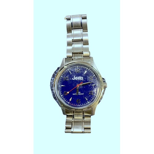 605 - A Jeep blue faced water resistant wristwatch with stainless steel strap. (2006). In Jeep metal tin w... 