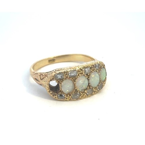 516 - An opal and diamond ring stamped 18ct, size P. One opal is missing and 2 are chipped. Weight 6.6g ap... 