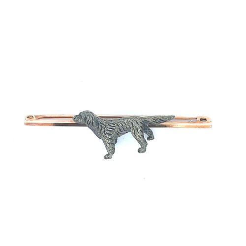 451 - A brooch stamped 9ct, mounted with an unmarked metal dog (pointer breed likely). Weight 7.39g. In a ... 