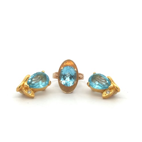 475 - A gold and topaz ring, stamped 9ct. Topaz 12mm x 10mm. Also a pair of blue paste earrings