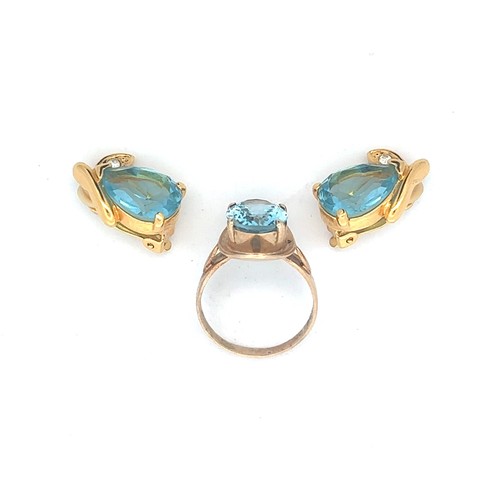 475 - A gold and topaz ring, stamped 9ct. Topaz 12mm x 10mm. Also a pair of blue paste earrings