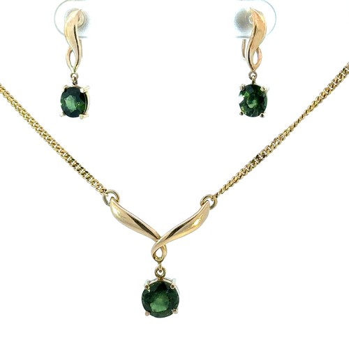 396 - A green sapphire pendant necklace and earrings set. Pendant stamped 585 and chain stamped 375. Earri... 