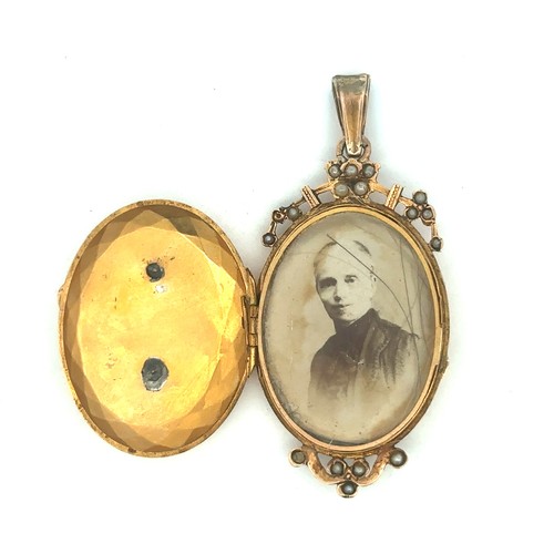 459 - An unmarked gold (tests as 15ct) and pearl locket. Glazed interior cracked.  Length 55m, weight 10g ... 