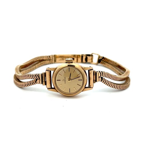 558 - Omega 9ct gold ladies wristwatch and bracelet, in branded box of issue with booklet/certificate date... 